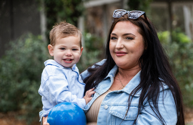 Mum and son looking at camera smiling